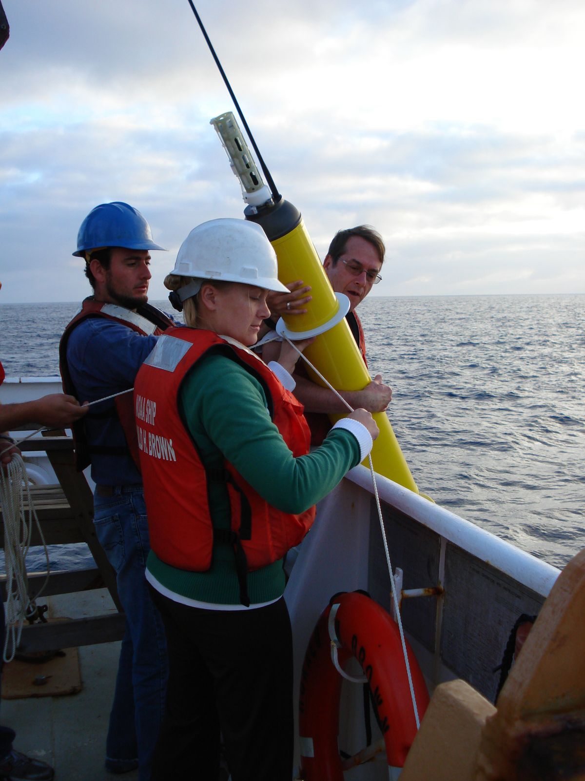 Crew members deploy an Argo profiling float over the side of NOAA Ship Ronald H. Brown.