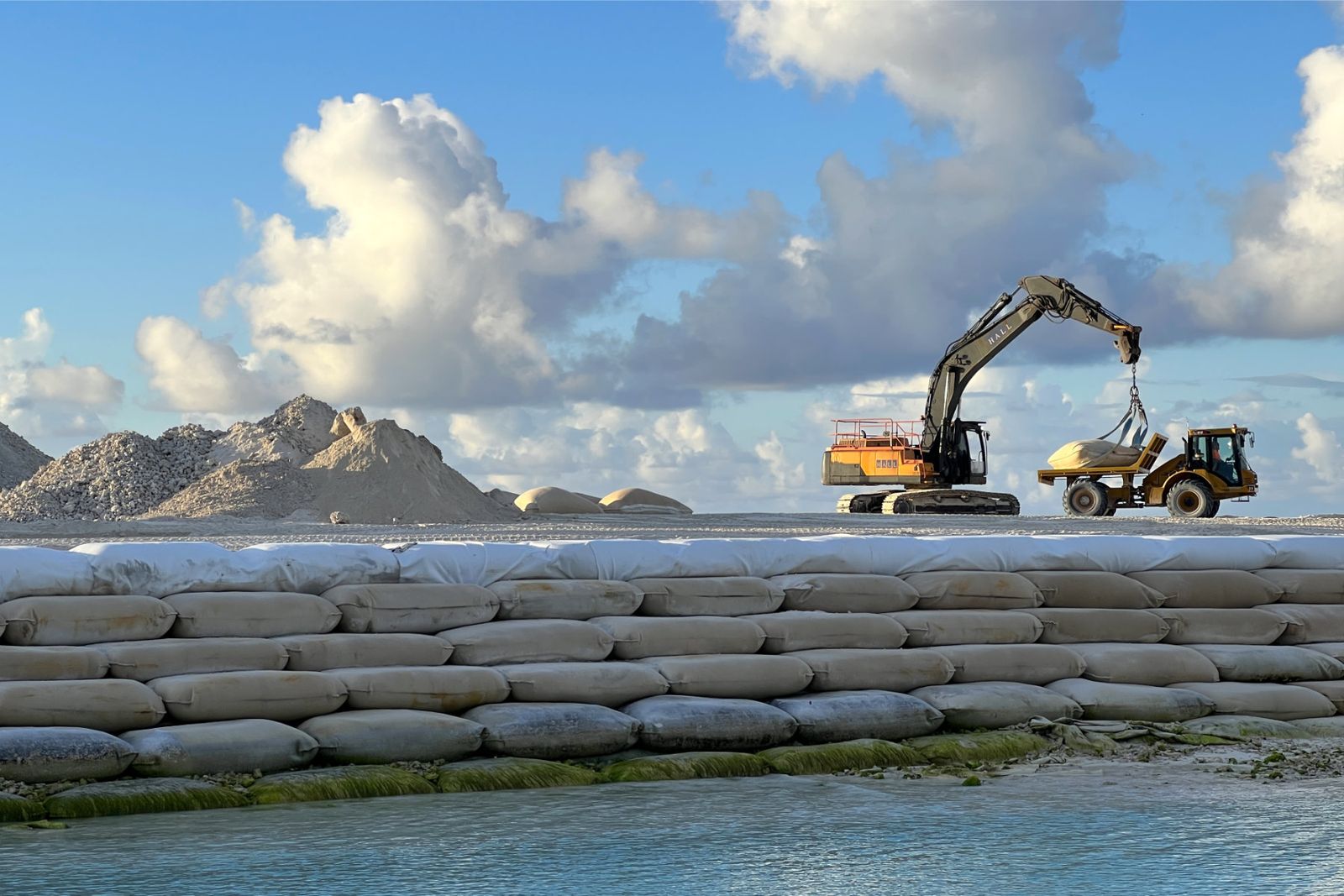 Sandbag and geotextile walls and heavy machinery at the Tuvalu Land Reclamation Project near Funafuti, which is building elevated land as a buffer against sea-level rise and storm surges (October 2025).